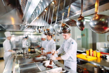 Modern kitchen. The chefs prepare meals in the restaurant's kitchen.