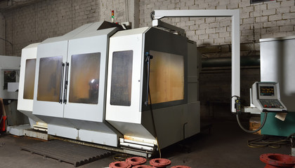 CNC machine for working with metal, slightly dirty, is in the factory. Cnc machine gray