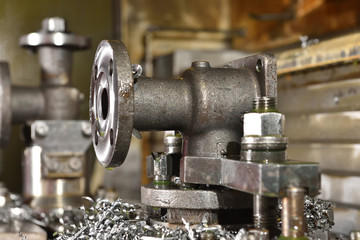 The body for creating the valve is installed on the table of the CNC machine for creating and grinding holes