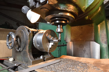 Spindle chuck and installed metal part in pocessing on high precision Cnc industrial lathe turning machine. CNC machine cuts off excess edges on metal part