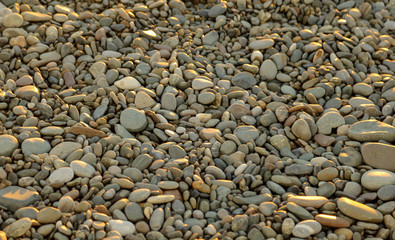 Stone pebbles on the seashore as an abstract background
