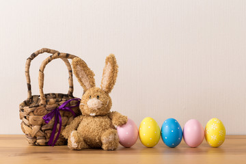 Easter bunny rabbit with  painted egg on wooden background