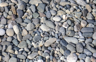 Stone pebbles on the seashore as an abstract background