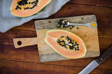 Papaya on a cutting board on a wooden table