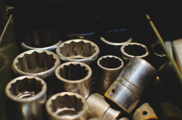 Looking into a tool tray holding the sized sockets in the vintage workshop. 
