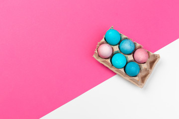 Obraz premium Candy color easter eggs over bright paper background