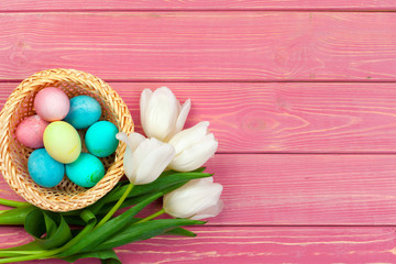 Obraz na płótnie Canvas Easter background. colorful eggs in a nest of straw