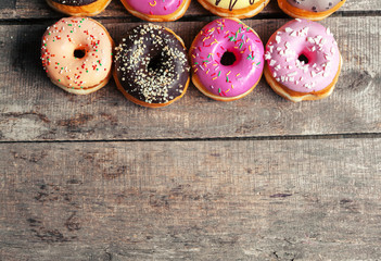 Glazed donuts on wooden background