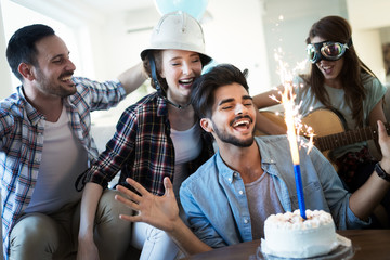 Cheerful young friends having fun on party