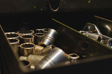 A view inside the old toolbox drawer in the old works shop filled with craft tools and parts. 