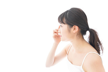 コンタクトレンズを装着する若い女性