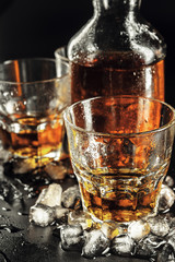 Glass of the whiskey and a square decanter