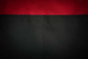 Background of red and black cloth fabric texture backdrop.