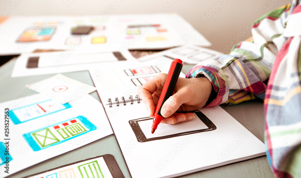 Poster developer designing user interfaces for mobile phone applications.
