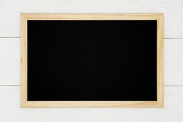 Blank chalkboard on white wood plank background. 