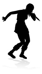 A woman singer pop, country music, rock star or even hiphop rapper artist vocalist singing in silhouette
