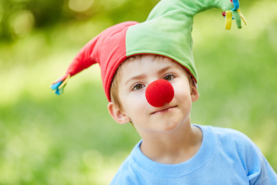 Boy with red nose and fool's cap