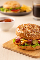 Burger with sliced pickle, onion and fried potatoes	