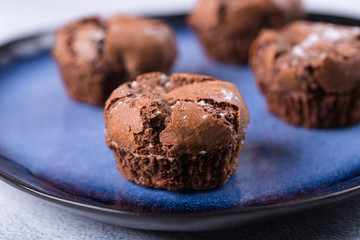 Tasty chocolate muffins on the blue plate