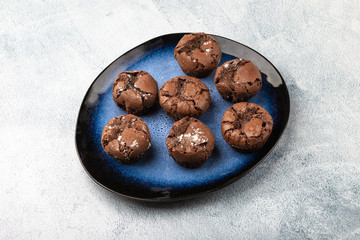 Tasty chocolate muffins on the blue plate