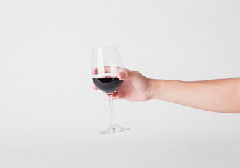 hand holding red wine glass on a white background.