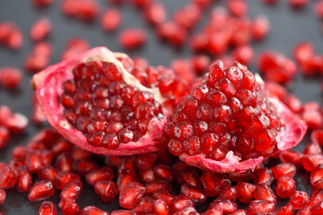 Close-up pomegranate and seeds scattered