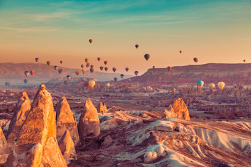 Hot air balloons in the sky over Cappadocia. - obrazy, fototapety, plakaty