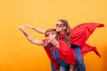 Mother and daughter dressed like superheros flying off save the world from villans