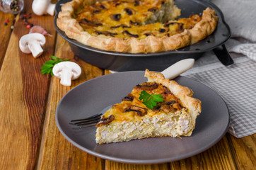 Quiche on puff pastry with leek, meat and mushrooms. Rustic style.