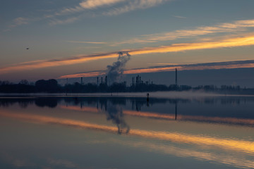 Dawn on a lake with industrial background