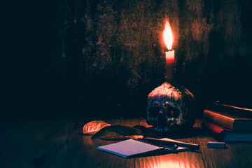 Skulls books pens and candles