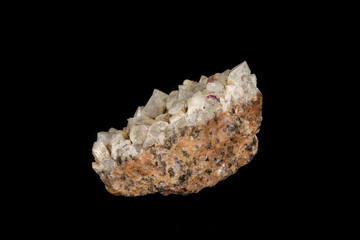 Macro mineral quartz stone with fluorite on granite on a black background