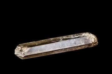 Macro mineral stone smoky quartz, rauchtopaz on a black background