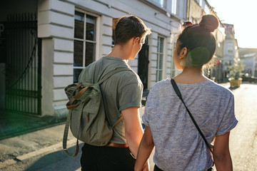 Young couple exploring the city together on foot