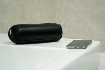 Bluetooth speaker plays music in a bathroom