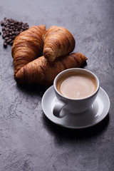 Breakfast with freshly baked croissants and cup of coffee