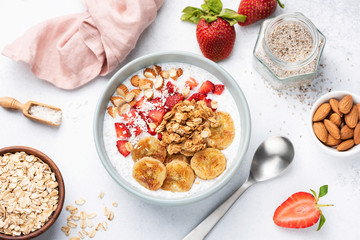 Yogurt bowl with superfoods, fruits and granola. Vegan or vegeterian breakfast, snack. Concept of clean eating, dieting, healthy eating and weight loss