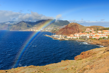 Obraz premium Beautiful rainbow landscape view of the coastline on the east coast of Madeira island, near Canical, with the atlantic ocean in summer