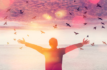 Copy space of man rise hand up on sunset sky at beach and island background.