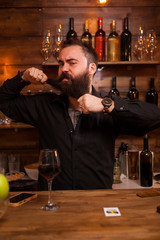 Bearded barman being funny with his beard
