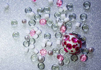 Easter composition flatlay. Easter eggs decorated with shiny rhinestones on  silver background with glass ornaments and pearl beads.