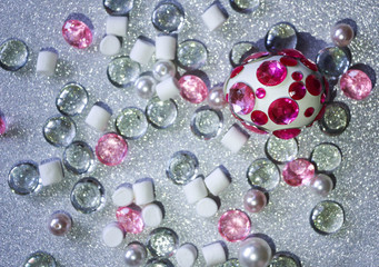 Easter composition flatlay. Easter eggs decorated with shiny rhinestones on  silver background with glass ornaments and pearl beads.