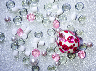 Easter composition flatlay. Easter eggs decorated with shiny rhinestones on  silver background with glass ornaments and pearl beads.
