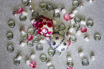 Easter composition flatlay. Easter eggs decorated with shiny rhinestones on  silver background with glass ornaments and pearl beads.
