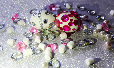 Easter composition flatlay. Easter eggs decorated with shiny rhinestones on  silver background with glass ornaments and pearl beads.