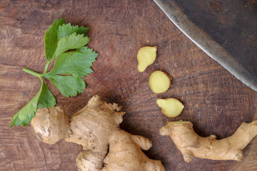 Ginger root sliced on wooden background
