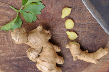 Ginger root sliced on wooden background