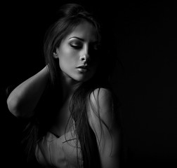 Beautiful makeup seriois woman with long hair looking sexy with half shadow on the face. Closeup...