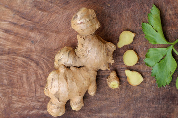 Ginger root sliced on wooden background