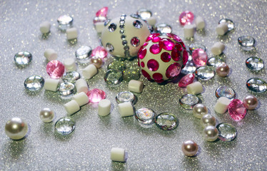 Easter composition flatlay. Easter eggs decorated with shiny rhinestones on  silver background with glass ornaments and pearl beads.